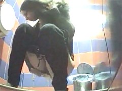 Two babes pissing in a spycammed beach toilet
