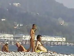 Young and pretty teen babe is ready to lie on the beach sand